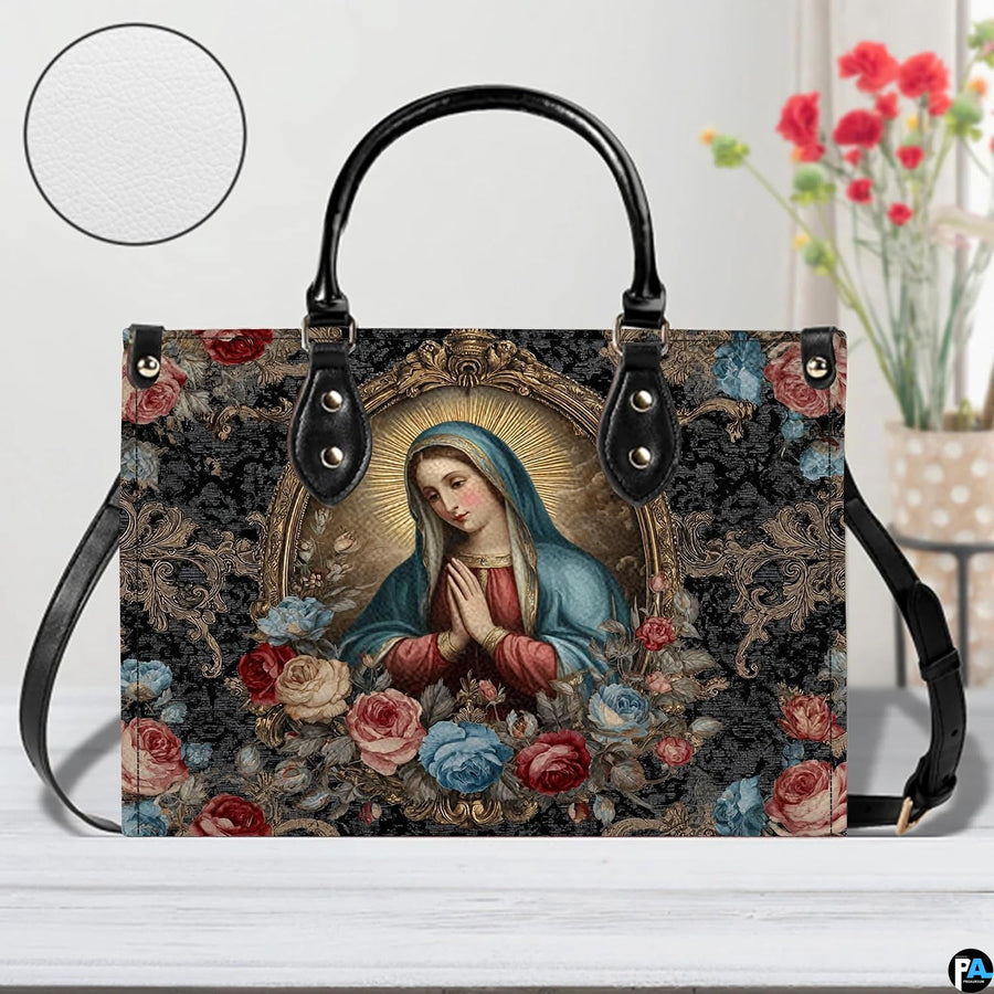 Handbag displayed on wooden tabletop with floral arrangement and material texture detail.