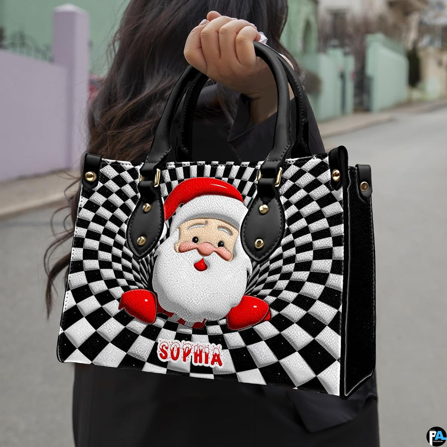 Lifestyle view showing handheld carry of optical illusion Santa handbag outdoors.