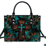 Side profile view of structured turquoise cross butterfly handbag.