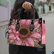 Street lifestyle perspective featuring pink sunflower art accessory held outdoors in natural daylight.