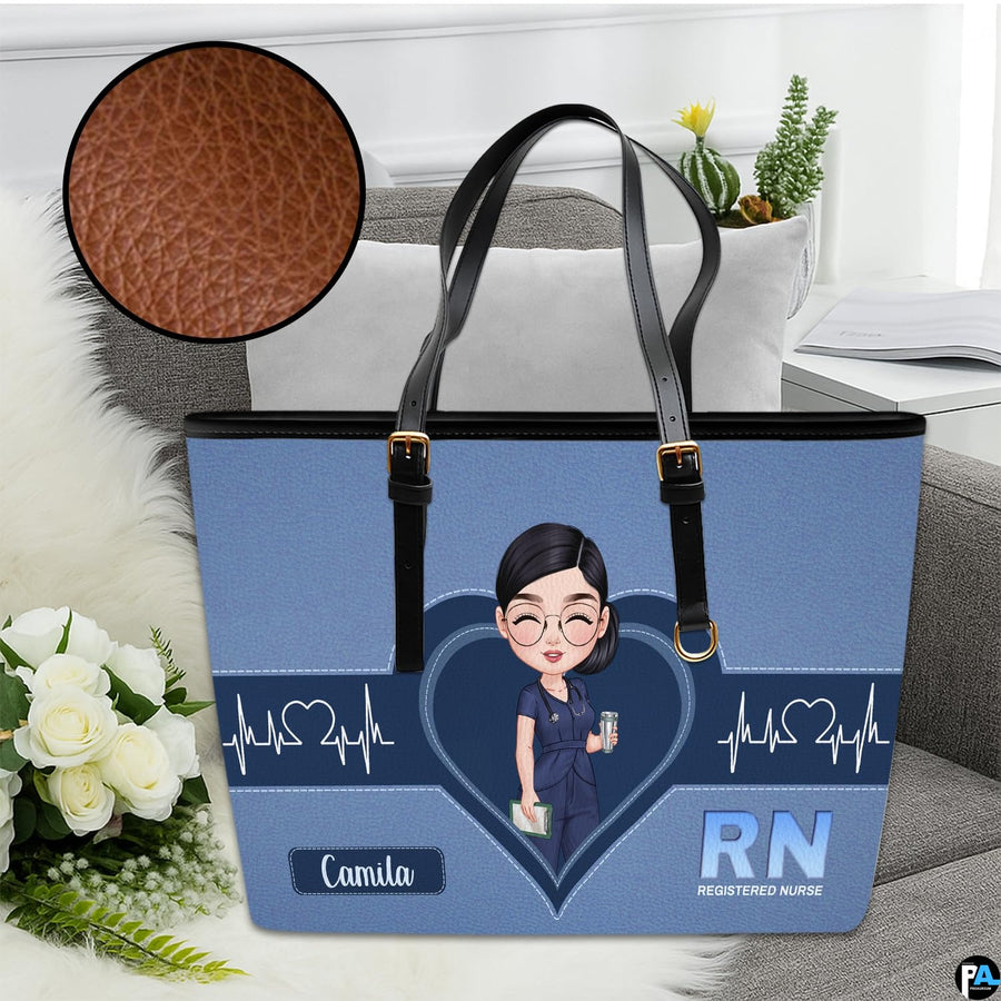 Studio view of Denim Blue Clinician Tote Handbag resting on sofa with texture zoom inset.