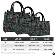 Matching zip-around wallet featuring sculpted bronze dragonfly inside ornate baroque frame on patina teal