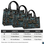 Matching zip-around wallet featuring sculpted bronze dragonfly inside ornate baroque frame on patina teal