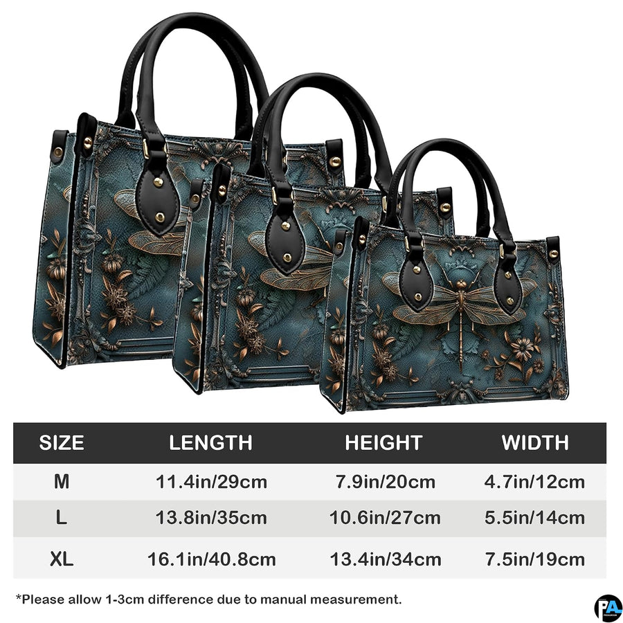 Matching zip-around wallet featuring sculpted bronze dragonfly inside ornate baroque frame on patina teal