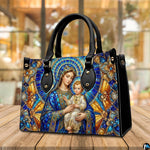 Tabletop display of stained glass Madonna handbag highlighting luminous amber and blue glass tones