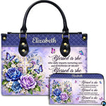 Christian cross butterfly floral handbag and matching wallet set on white background.