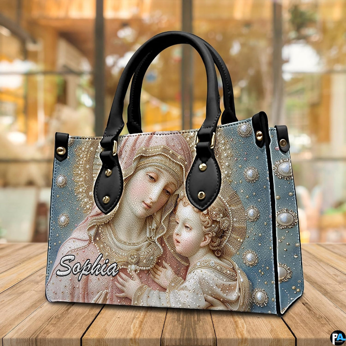 Madonna and Child devotional handbag presented on natural wooden table