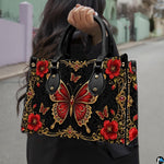 Outdoor lifestyle perspective showing baroque red butterfly artwork held by pedestrian along street.