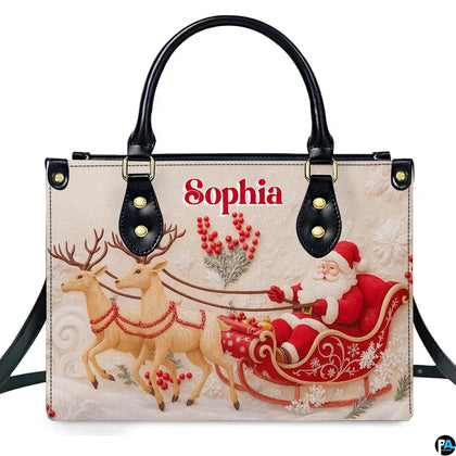 Front view of holiday handbag featuring Santa in ornate red sleigh guided by two reindeer on ivory background