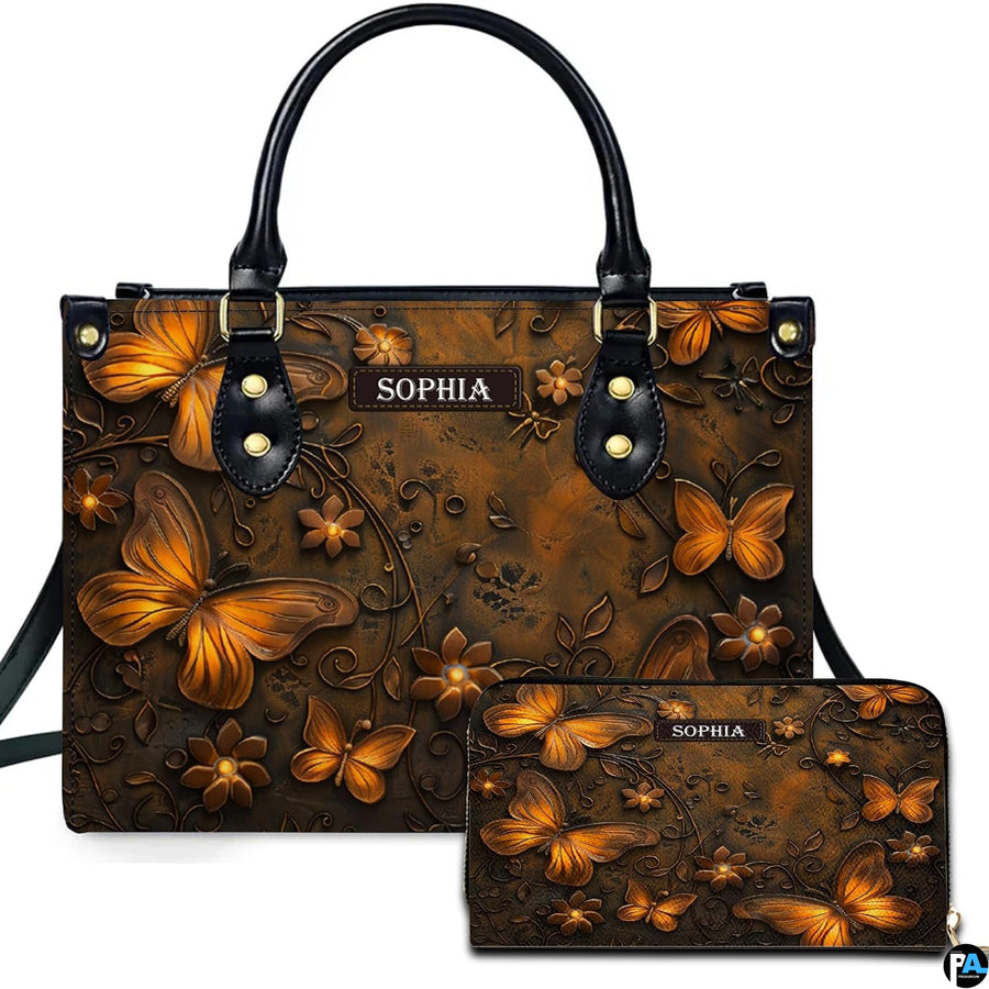 Golden bronze butterfly handbag and matching wallet set shown against a clean white studio background.