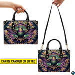 Handbag standing upright on wooden tabletop in softly lit indoor room.