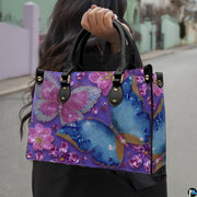 Model outdoors carrying purple jeweled crystal butterfly handbag