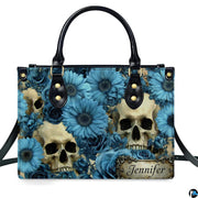 Gothic skull blue floral daisy handbag displayed alone on white studio background.