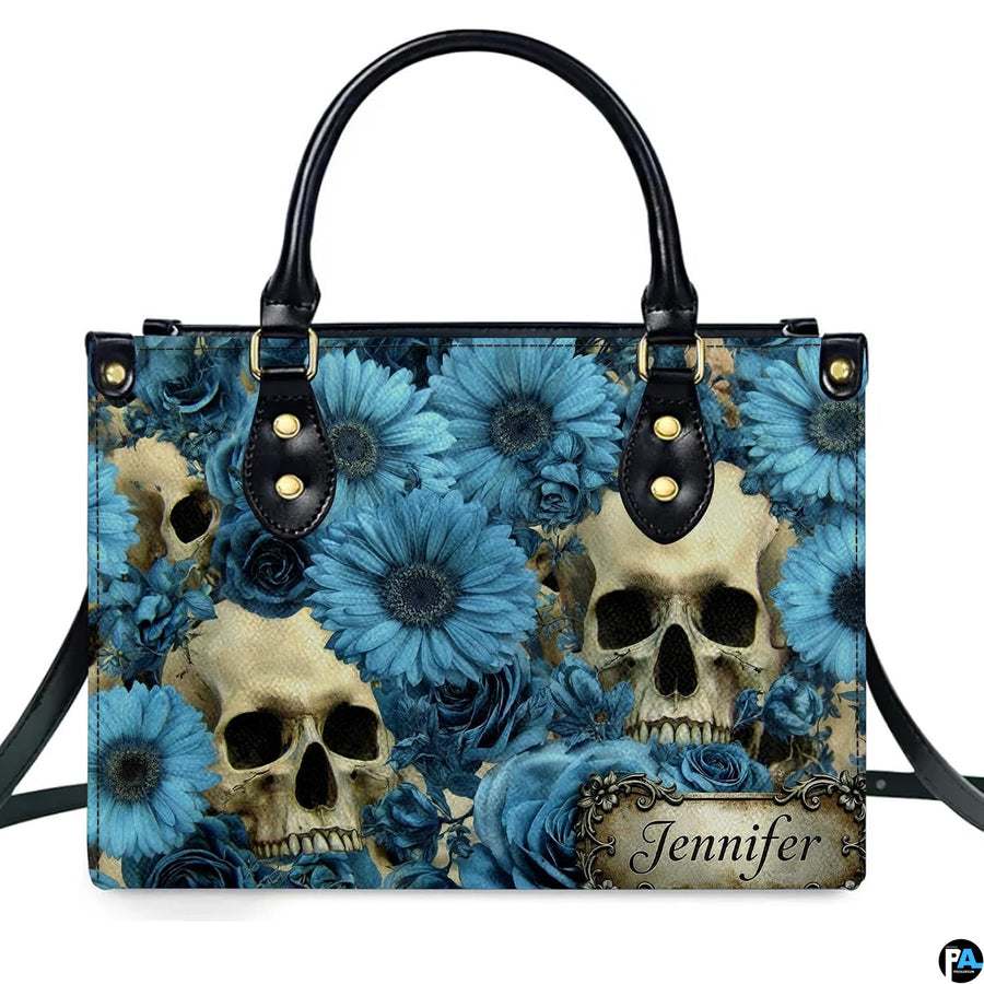Gothic skull blue floral daisy handbag displayed alone on white studio background.