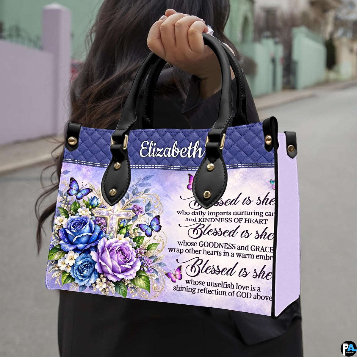 Floral cross handbag carried outdoors by top handle on residential street.