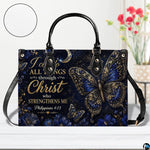 Frontal presentation displaying ornate blue and gold butterfly design on light wooden surface beside blooms.