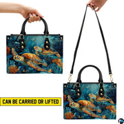 Matching wallet featuring two golden sea turtles gliding amidst aquatic plants.