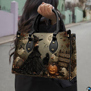 Dark gothic witch art accessory held outdoors showcasing moonlit cemetery scenery, sorceress gown, and ghosts.