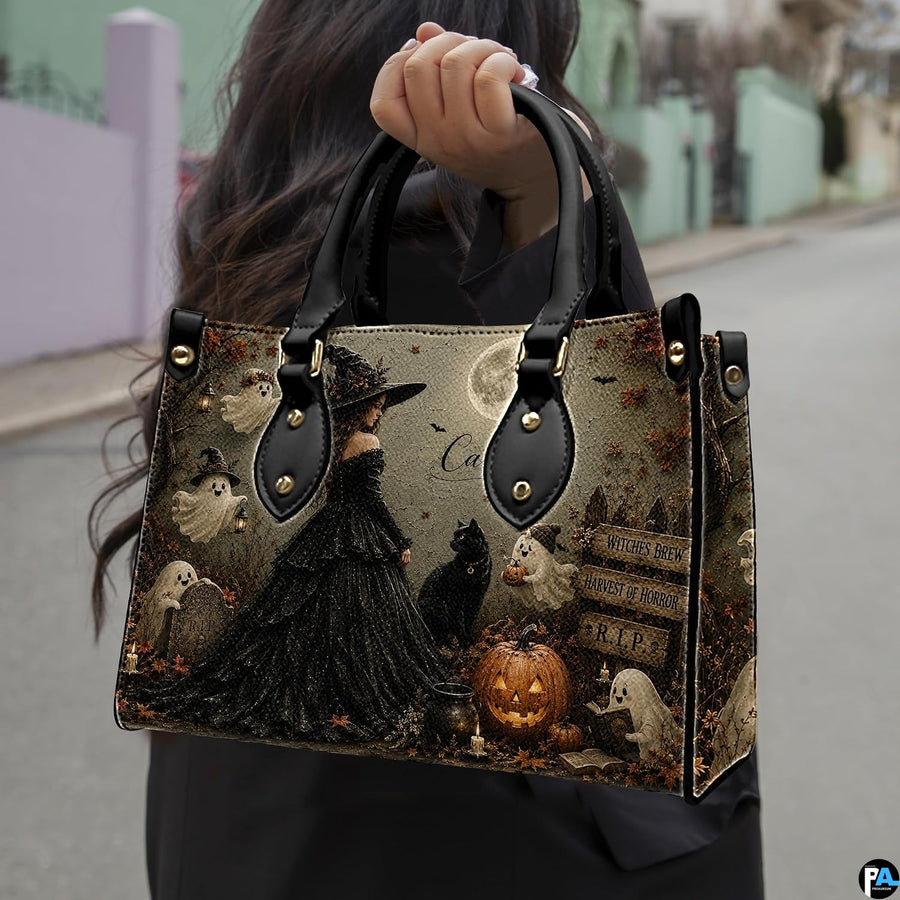 Dark gothic witch art accessory held outdoors showcasing moonlit cemetery scenery, sorceress gown, and ghosts.