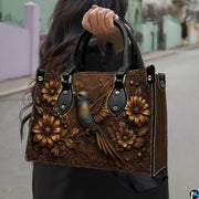 Angled display of sculpted botanical relief purse paired with coordinating zippered wallet companion.