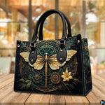 Side profile of gold dragonfly handbag showing continuous botanical medallion print along gusset