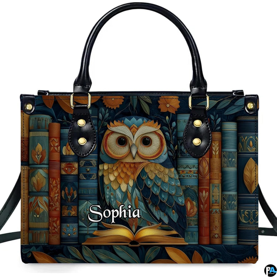 Front view of Scholarly Owl Library Handbag with teal owl perched on open book before antique spines