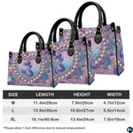 Back view of mermaid handbag showing coordinated pastel glitter and seashell pattern.