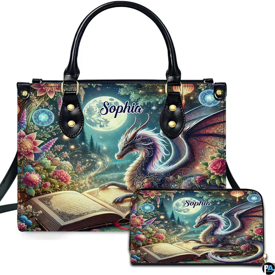Celestial iridescent dragon and open grimoire handbag and matching zip wallet set shown beneath full moon.