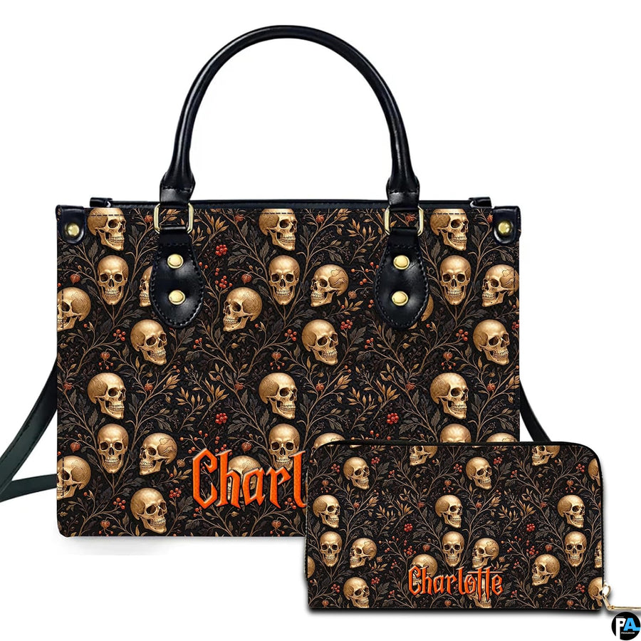 Dark botanical skull pattern with golden bone portraits and red berries beside matching accessory surface.