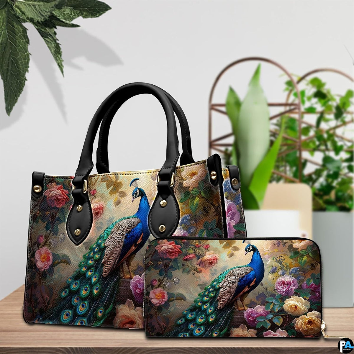 Peacock and rose handbag beside a matching wallet on a tabletop
