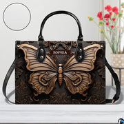 Artisan butterfly handbag displayed on a white surface alongside floral decor and a circular material swatch.