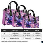 Complete set presentation of purple dual hummingbird handbag and matching wallet on neutral backdrop.