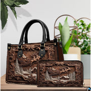 Carved Santa sleigh handbag and wallet displayed on wooden table before indoor plants.