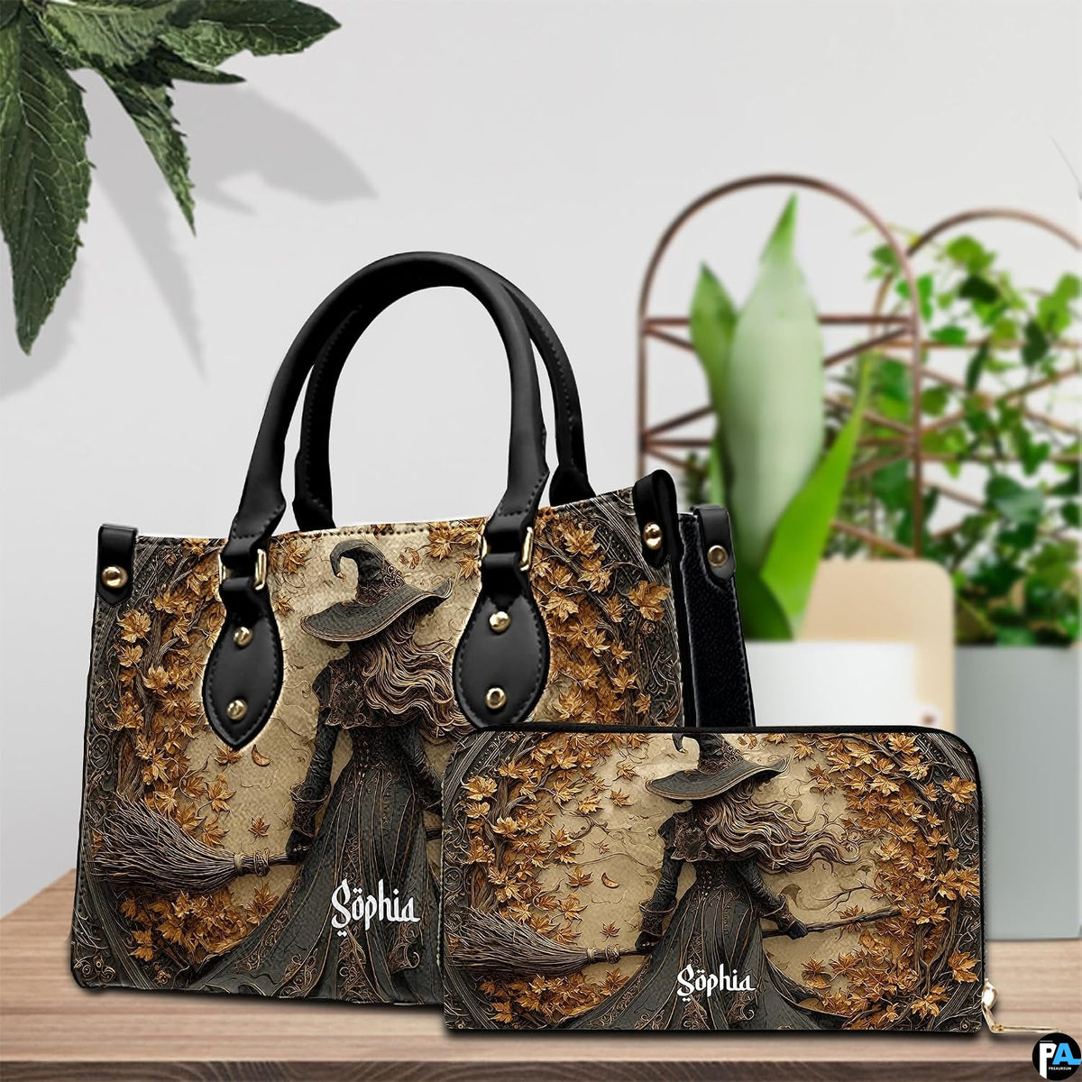 Gothic autumn witch handbag and matching wallet set on wooden table near houseplant.