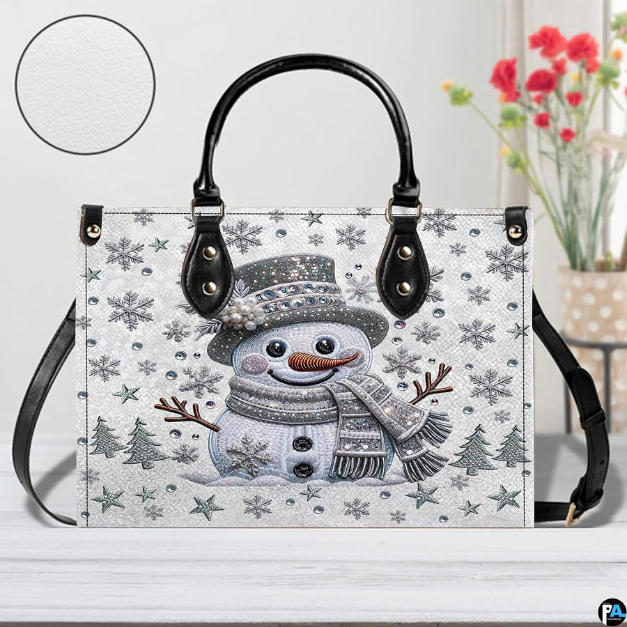 Front perspective highlighting glittering crystal snowman, pearl-accented top hat, and silver pine tree graphics.