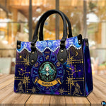 Tabletop perspective of Celestial Maiden Satchel Handbag resting on indoor wooden surface.