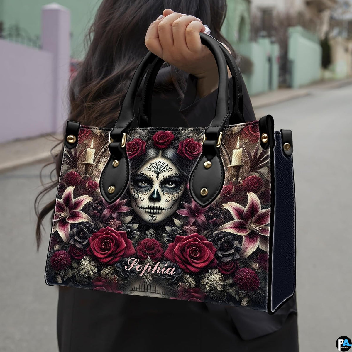 Sugar skull handbag carried by top handle while walking outdoors along a residential street.