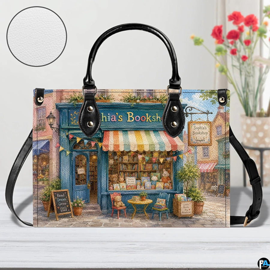 Angled view displaying the colorful boutique streetscape printed across the structured handbag.