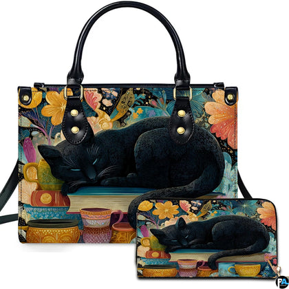 Studio presentation of sleeping black cat art alongside matching rectangular companion accessory.