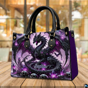 Gothic dragon handbag displayed on rustic wooden table in cafe setting.