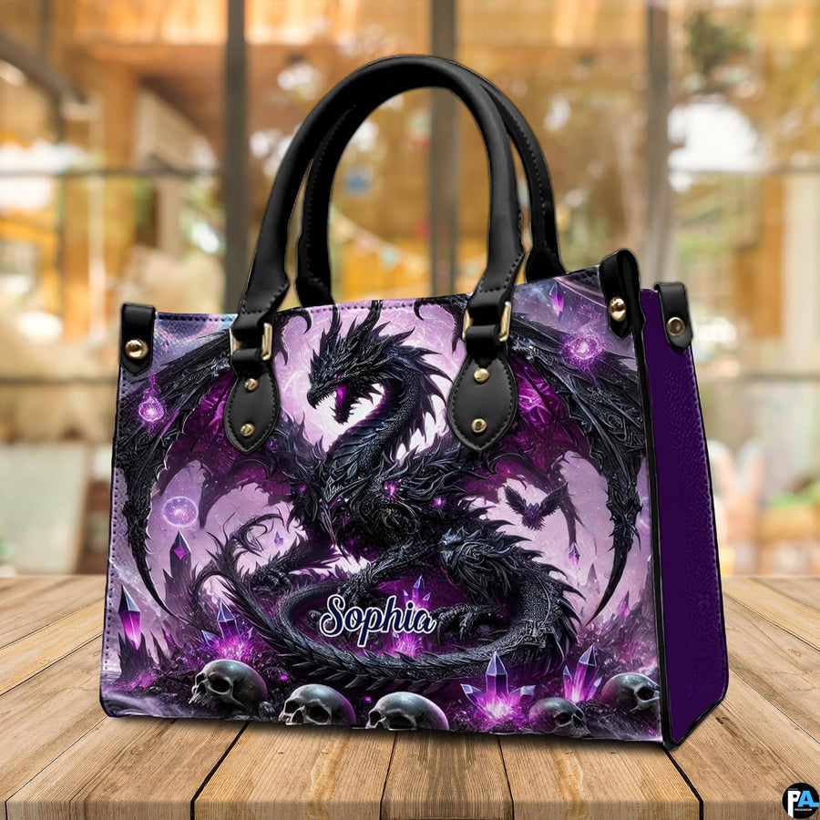 Gothic dragon handbag displayed on rustic wooden table in cafe setting.
