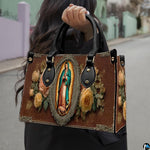 Matching wallet displaying Virgin of Guadalupe devotional artwork with radiant aura and roses