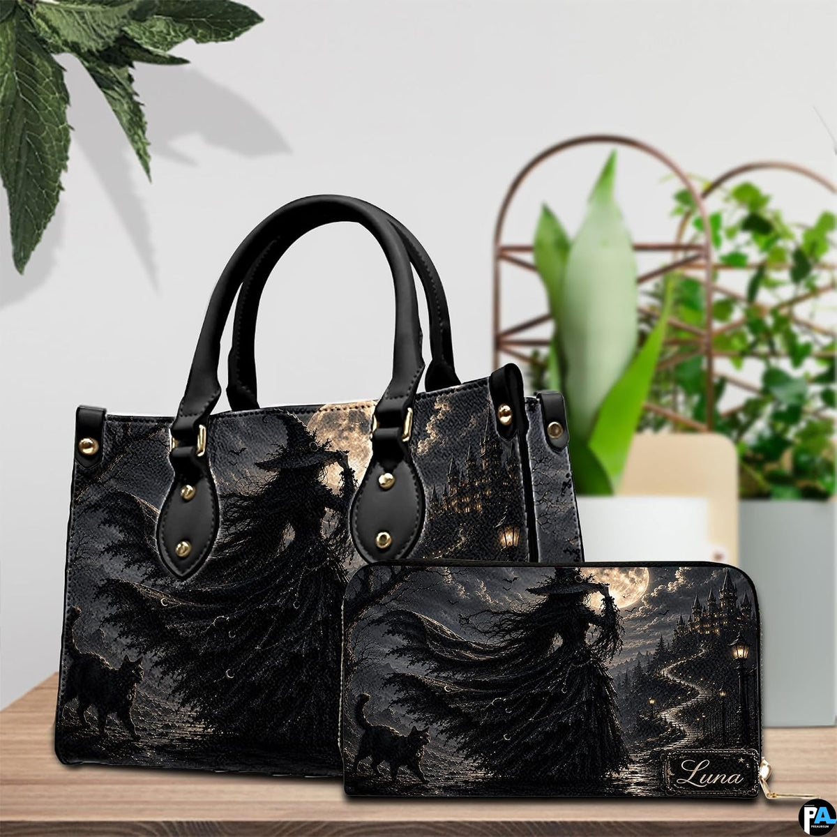 Still life tabletop arrangement showcasing the gothic witch artwork accessory alongside decorative foliage.