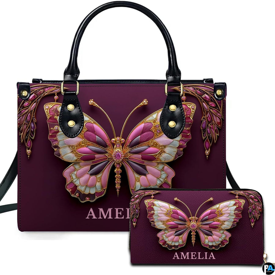Front view of jeweled butterfly handbag and wallet set featuring pink and gold filigree butterfly on plum