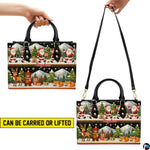 Side angle view of structured handbag showing profile silhouette, durable black trim, and festive graphic wrap.