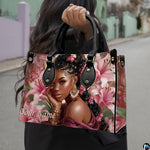 Carried perspective outdoors showing woman with braided updo and pink lilies on an urban background.