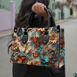 Perspective view of butterfly daisy relief handbag and wallet pair