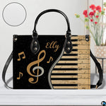 Tabletop presentation of musical piano artwork positioned beside floral vase and texture swatch.