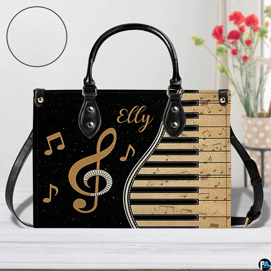 Tabletop presentation of musical piano artwork positioned beside floral vase and texture swatch.