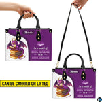 Dual display showing handheld top handle and shoulder strap carrying arrangements.